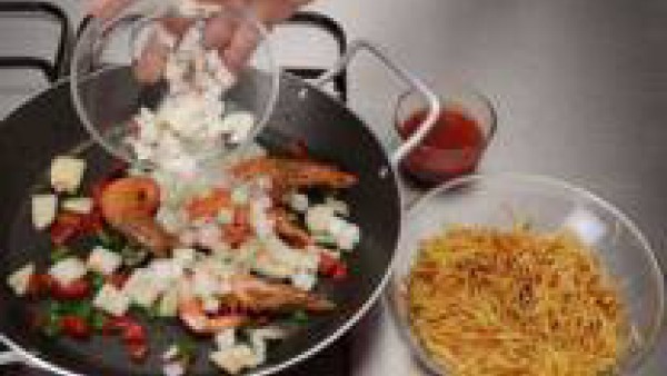En la misma paellera, saltea la sepia troceada, junto con el pimiento verde i el bote de sofrito de hortalizas, sazona con Avecrem Pescado -30% de Sal. Añade un poco de Caldo para Fideuá Fácil 100% Na