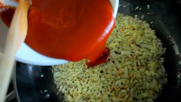 Mientras, en una sartén con un poco de aceite, sofríe la cebolla, picada. Cuando empiece a tomar color, añade el Tomate Frito Gallina Blanca y condimenta con el orégano, la pimienta y el pimentón. Dej