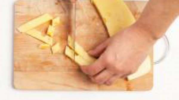 Corta el queso en cuadraditos y chafa las nueces.