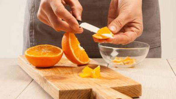 Pela las naranjas y córtalas en trozos pequeños. Vierte los trozos en las lentejas y mezcla.