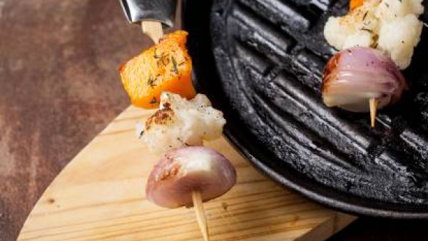 Sirve las brochetas de verduras acompañadas de salsa picante.